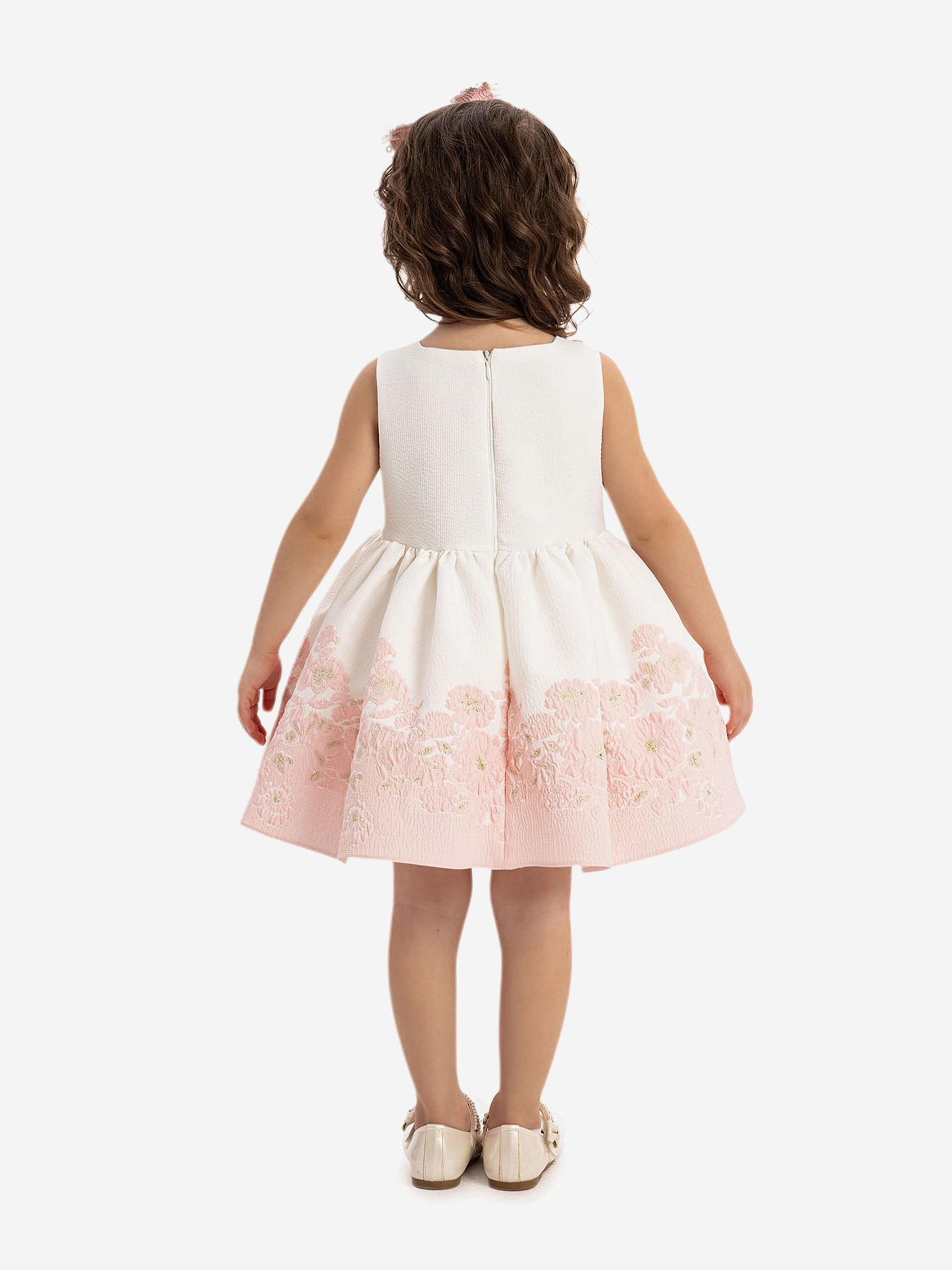 Back view: white sleeveless dress with pink floral hem panel and gathered skirt