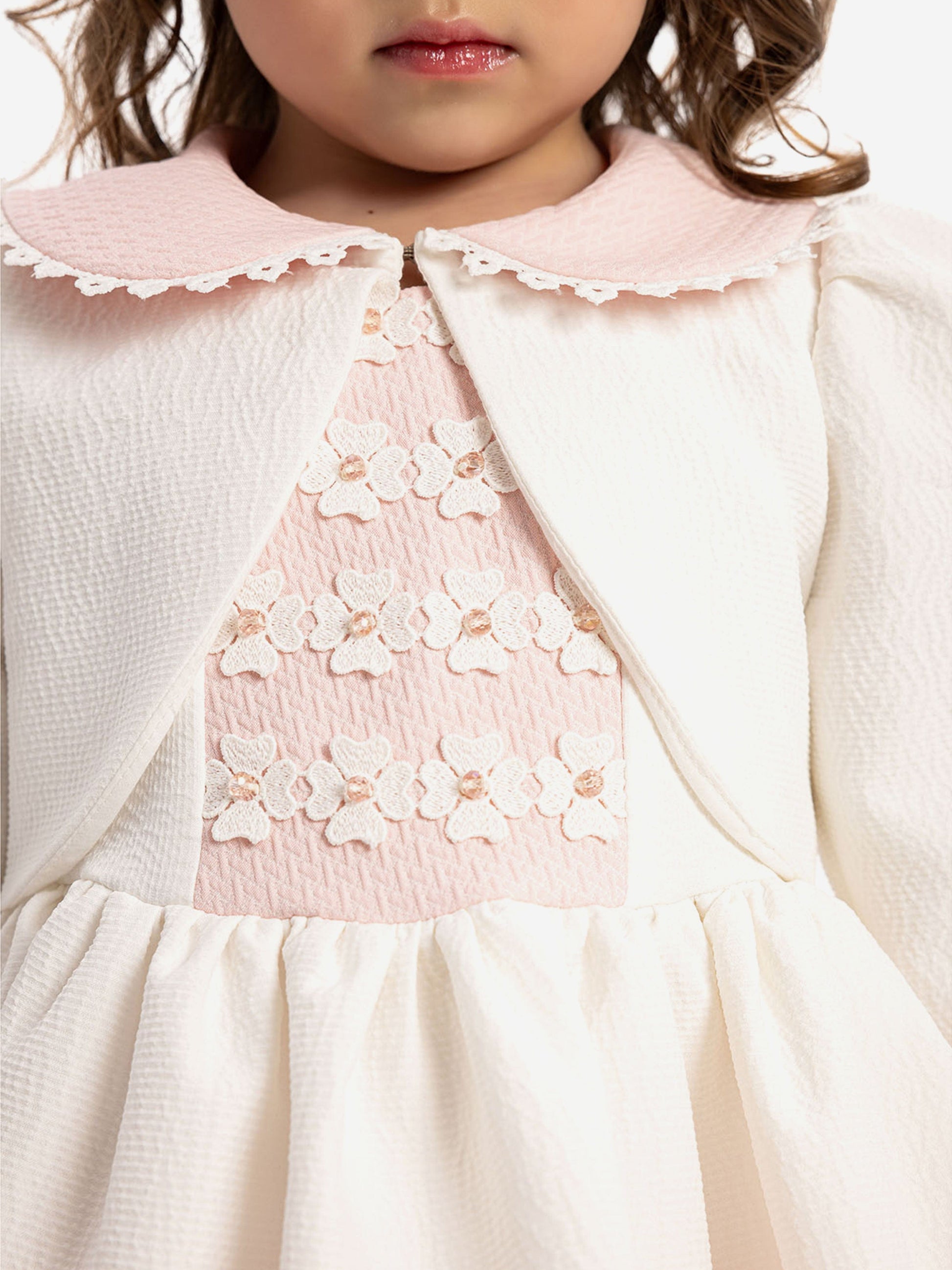 Close-up: white collar bolero with pink floral yoke and lace trim dress