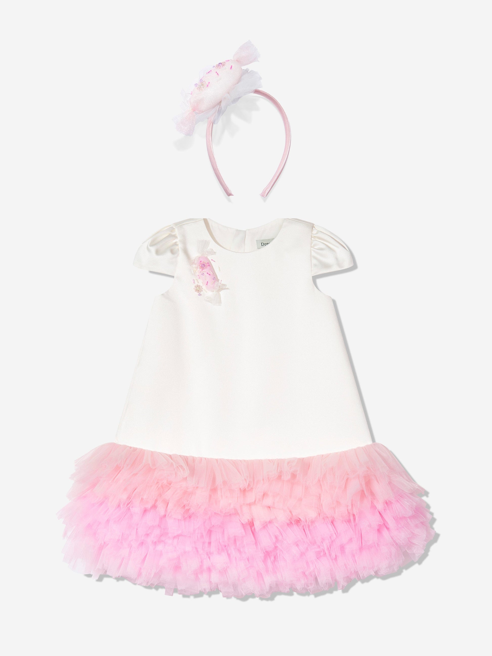 Ivory dress with puff sleeves, pink tulle skirt, and matching bow headband