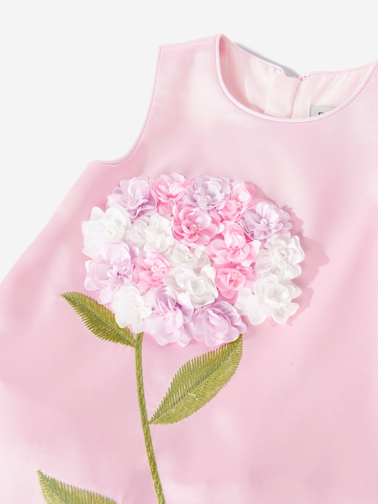 Close-up of pink dress bodice with layered floral appliqué