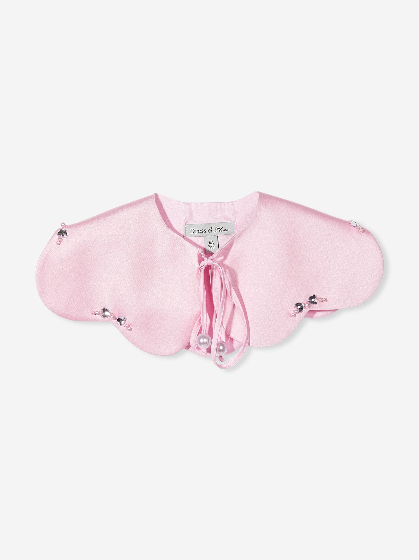 Cape close-up: pink heart cape with tie bow and pearl button accents