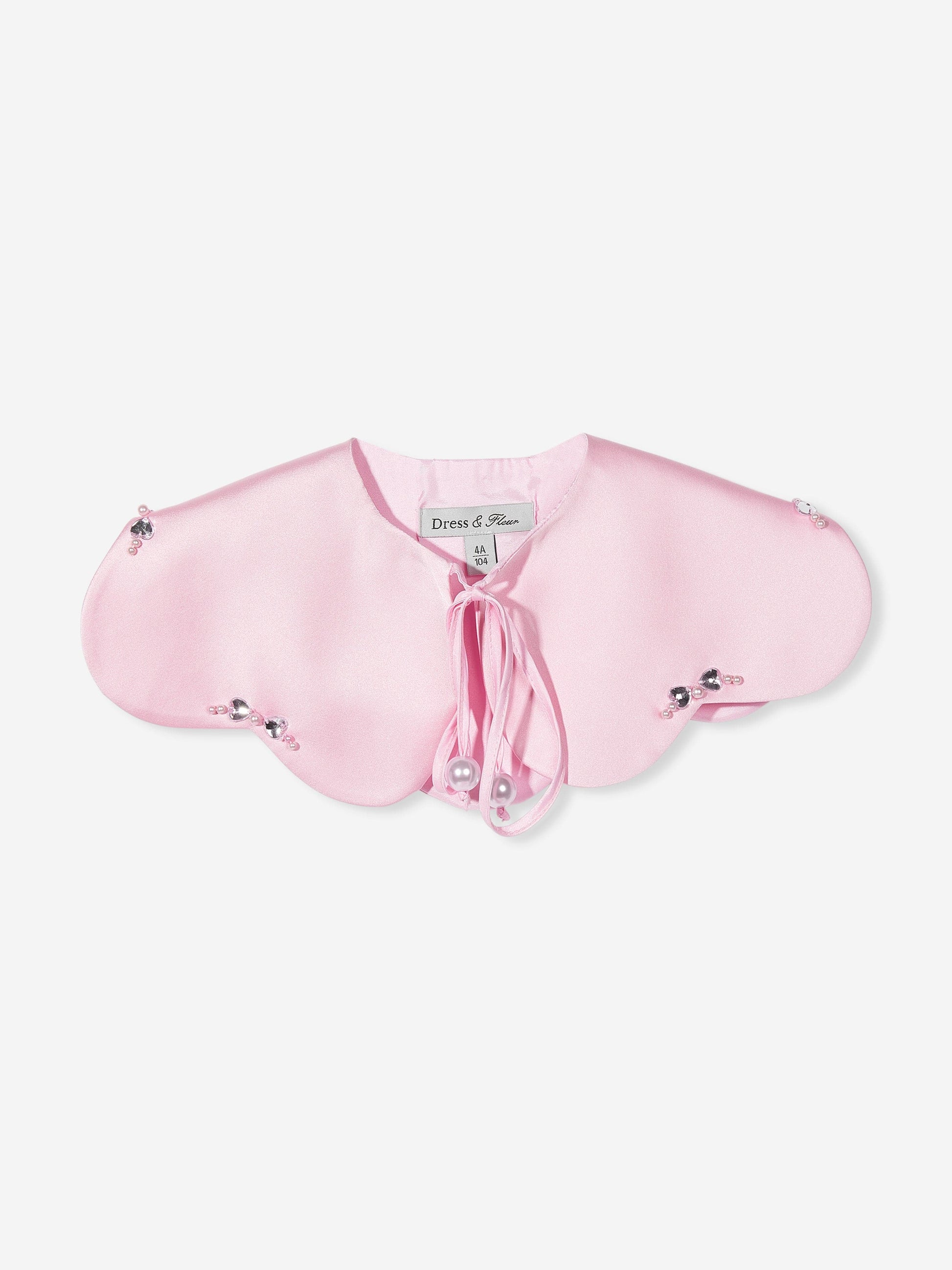 Cape close-up: pink heart cape with tie bow and pearl button accents