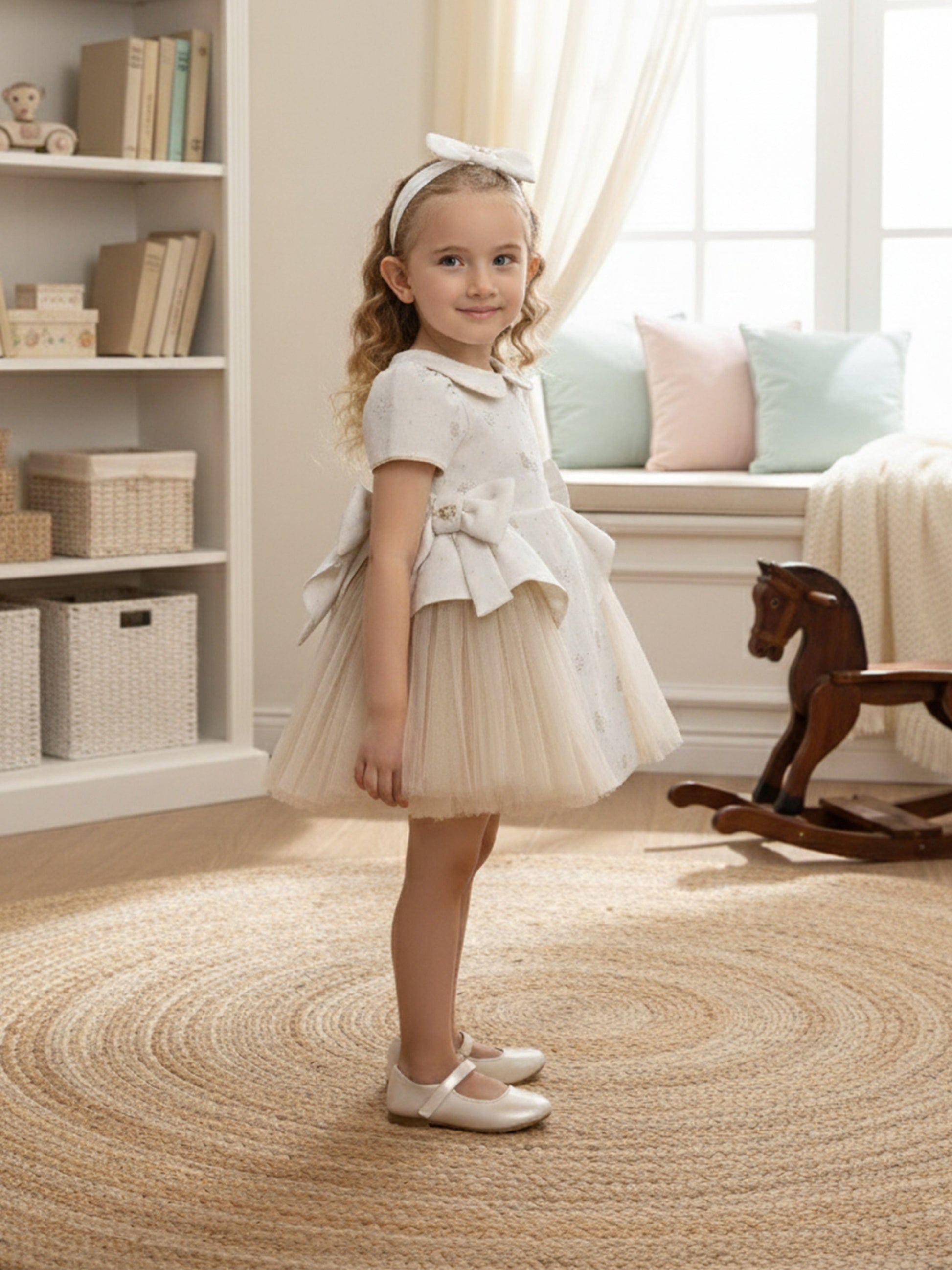 Ivory occasion dress with bow waist and tulle skirt, girl wearing headband