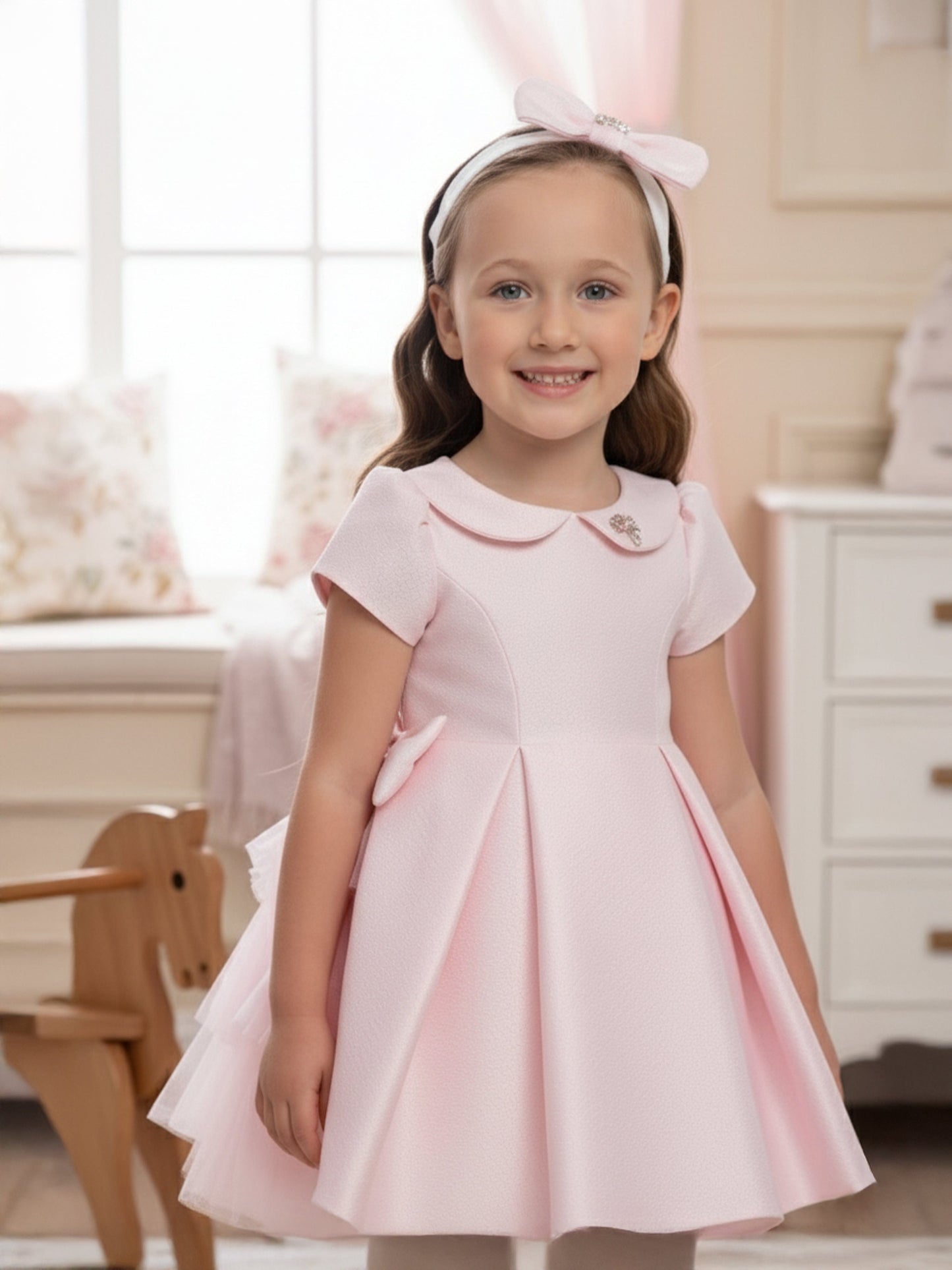 Pink occasion baby dress with short sleeves, pleated skirt and matching headband