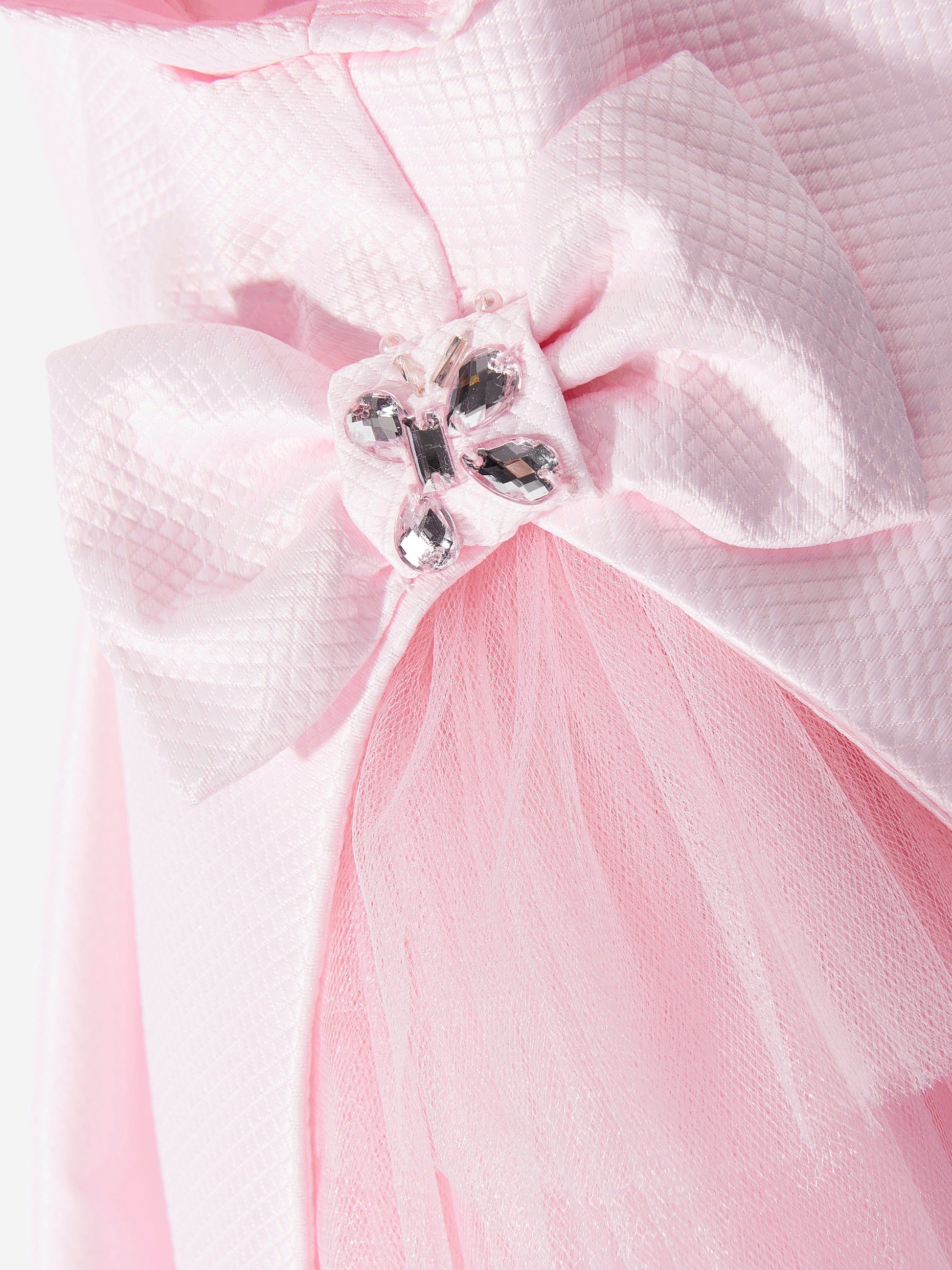 Pink headband bow close-up with gem-style center detail