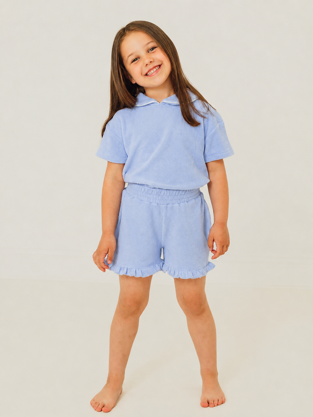 Light blue towelling short set with frilled hem and short-sleeve top, matching shorts