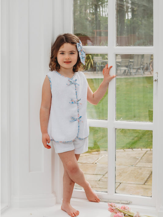 White towelling sleeveless top and shorts set with blue floral trim and bow neckline