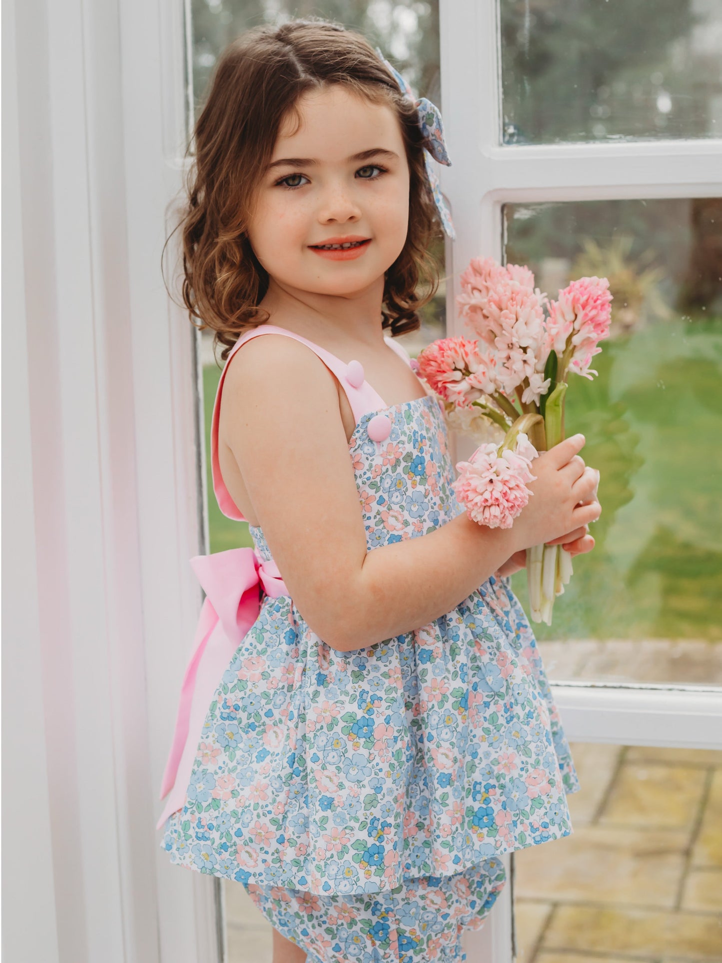Floral bow-back bloomer set with pink ribbon straps and light blue floral dress