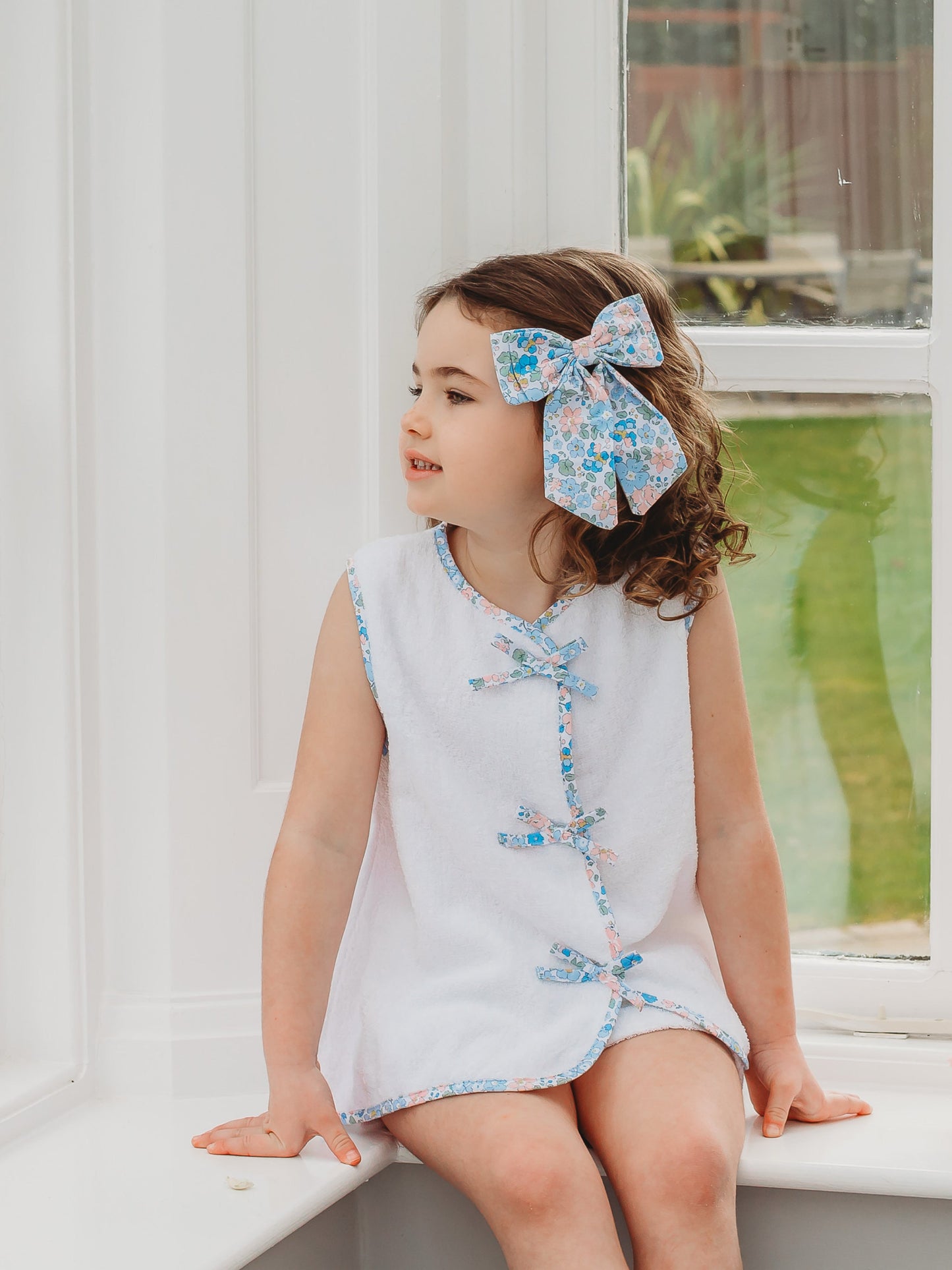 White towelling sleeveless top and shorts with blue floral trim and scalloped neckline