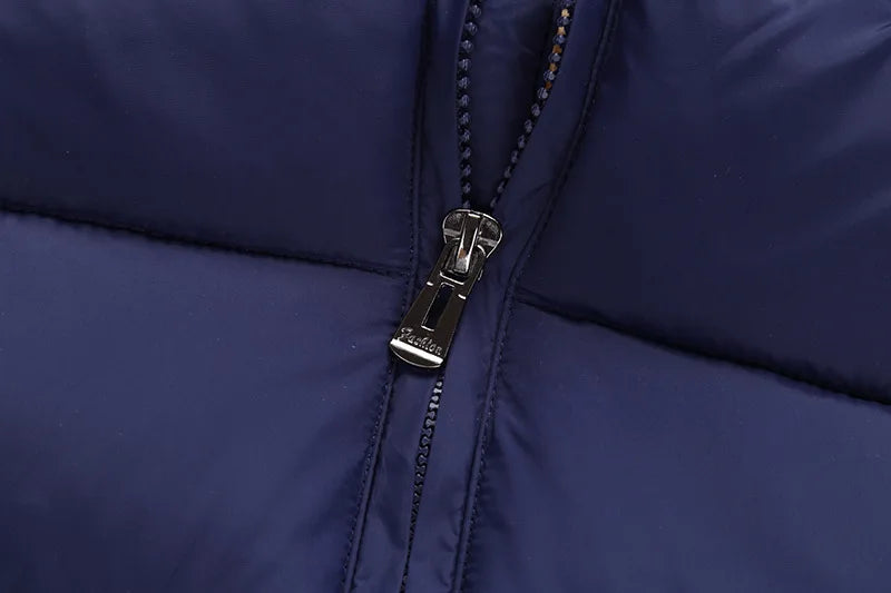 Navy blue puffer jacket close-up of front zipper with metal pull tab