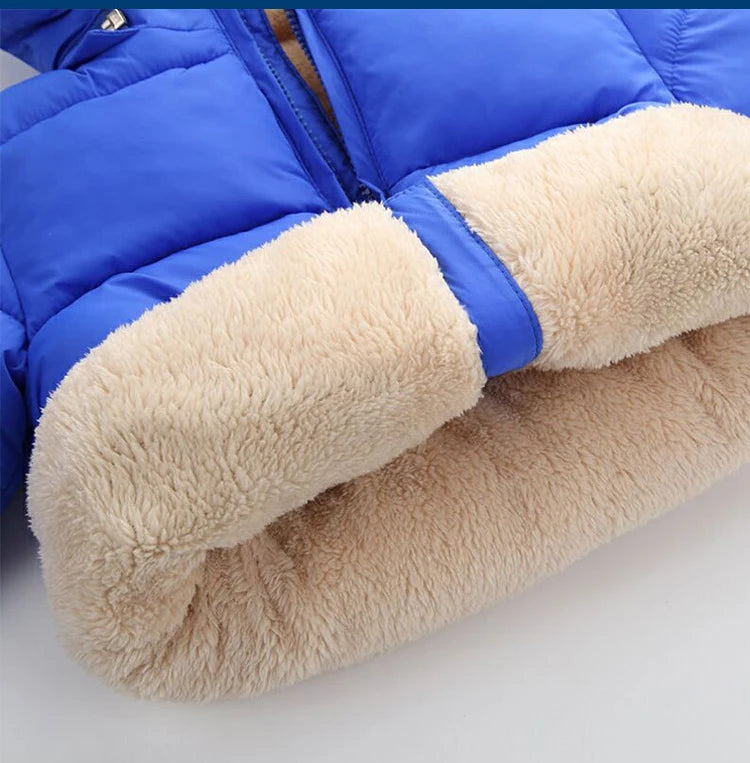 Blue winter puffer jacket sleeve with tan sherpa cuffs and padded quilted fabric