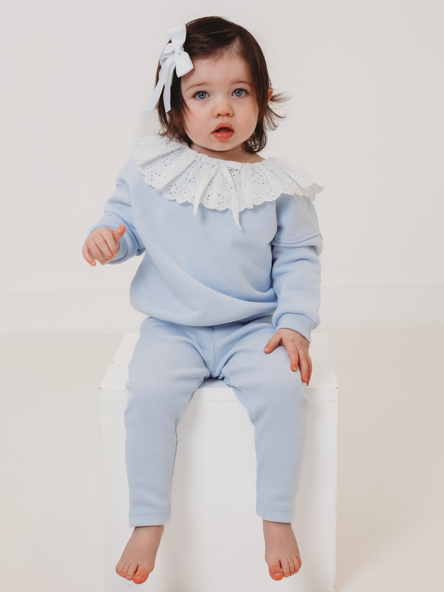 Light-blue kids top and ribbed leggings set, lace frill collar and tassel ties