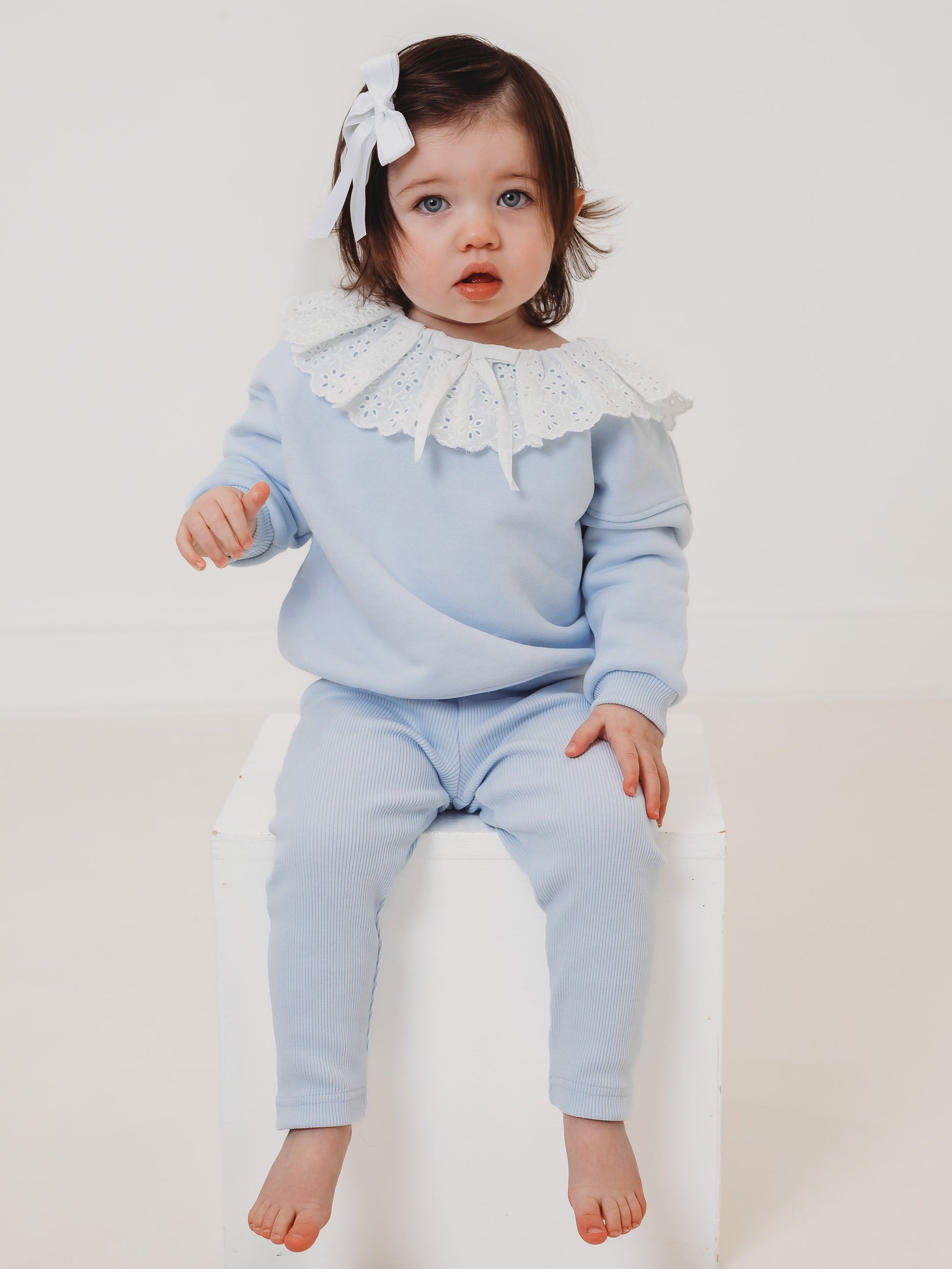 Light-blue kids top and ribbed leggings set, lace frill collar and tassel ties