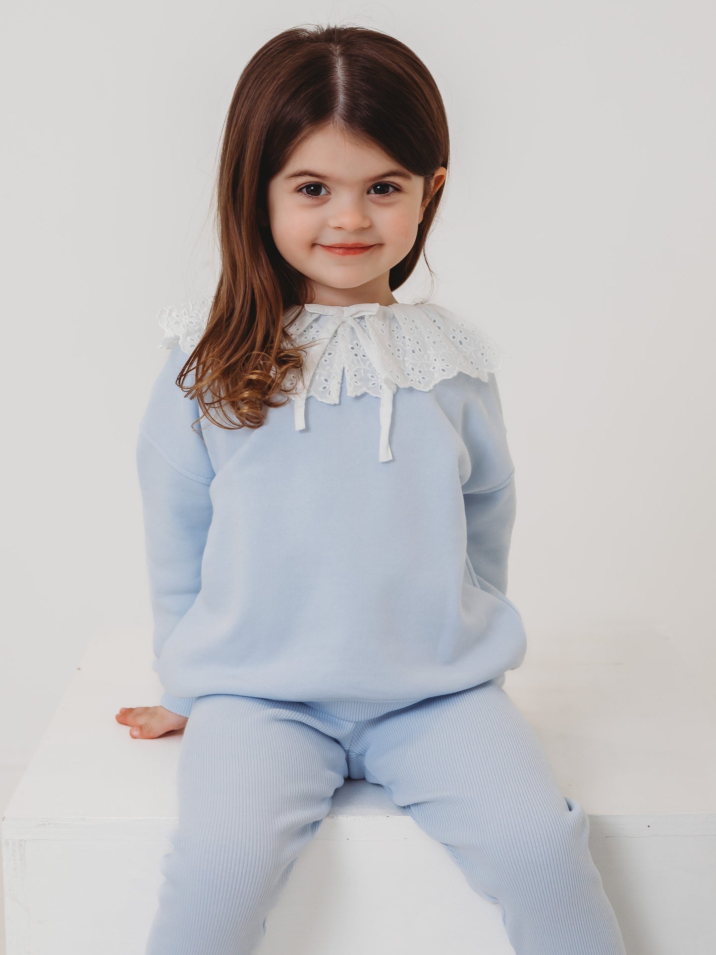 Light-blue kids top and ribbed leggings set with white eyelet lace frill collar