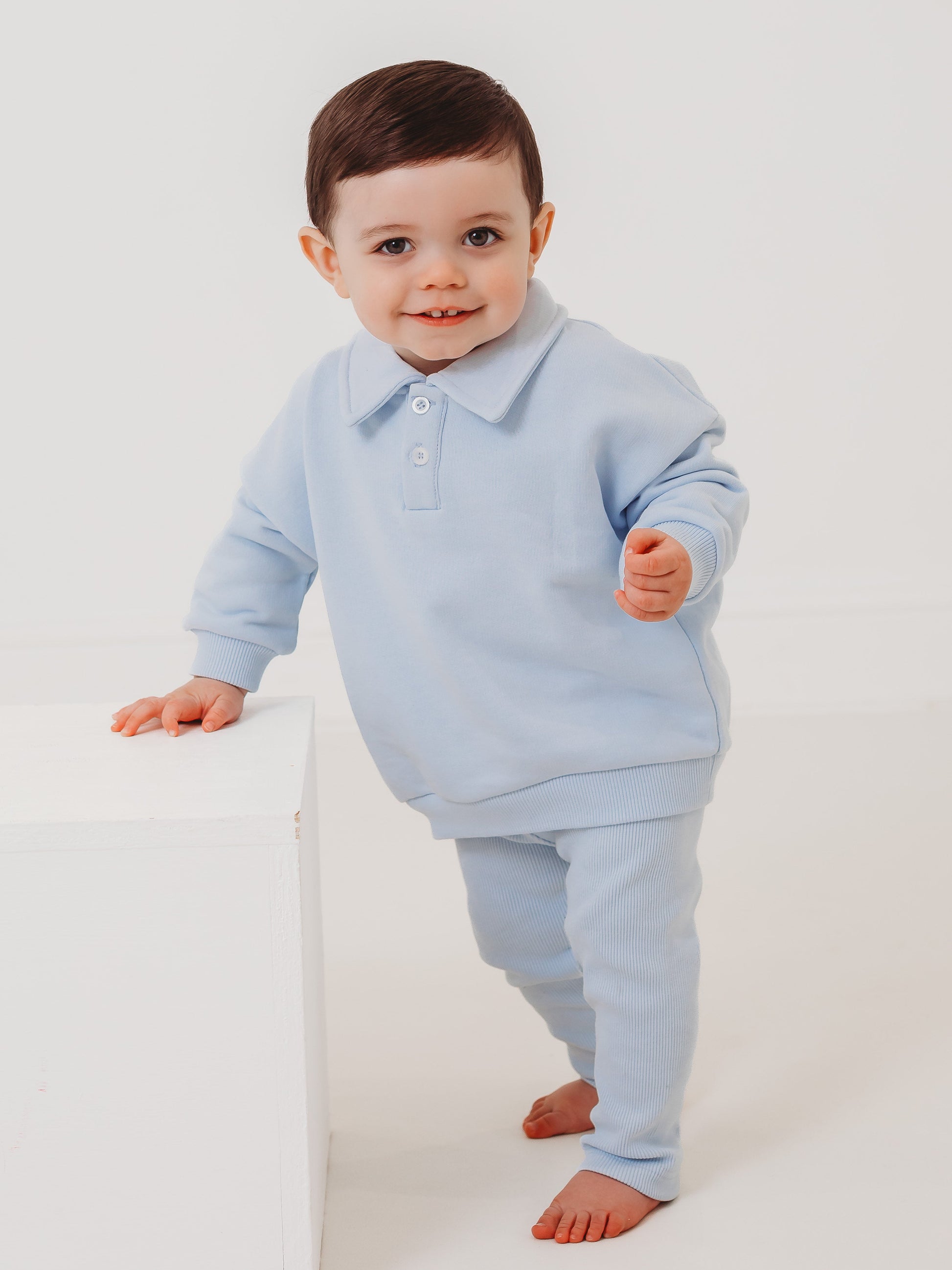 Light blue polo collar top and ribbed leggings set, toddler leaning forward