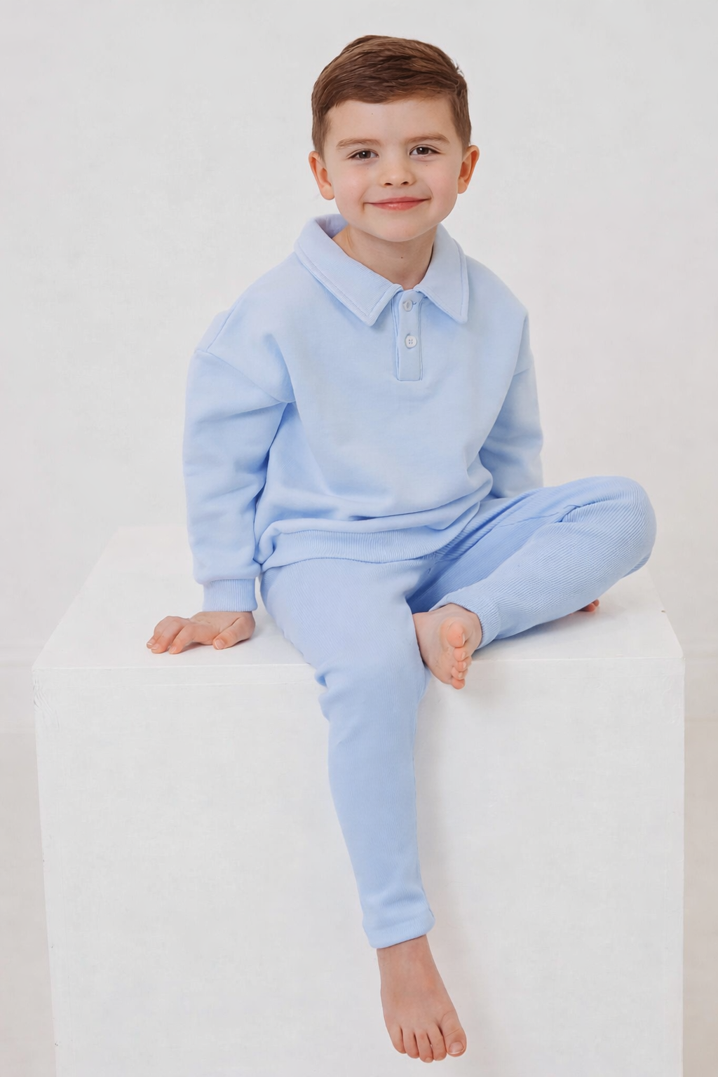 Light blue polo collar top and ribbed leggings set, toddler sitting cross-legged