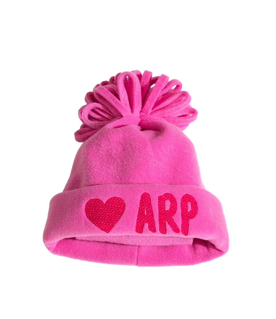 Pink fleece beanie with top pom and heart 'ARP' patch