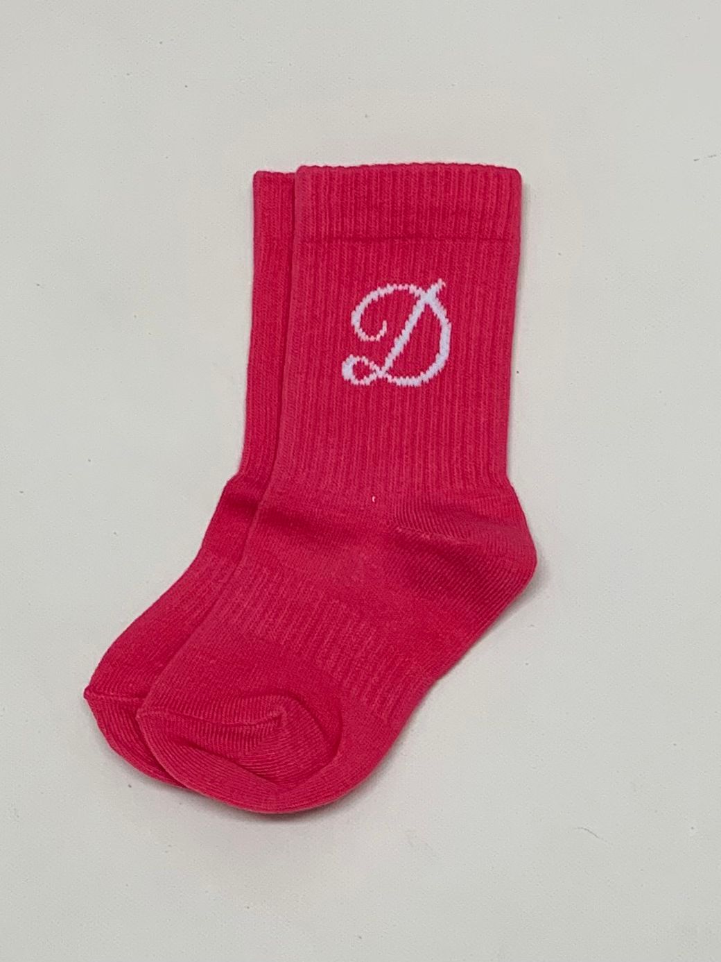 Fuchsia sport socks with white embroidered "D" logo