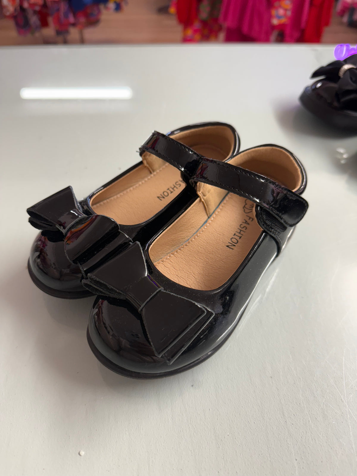 Girls' patent school shoes with bow, black Mary Jane style and buckle strap