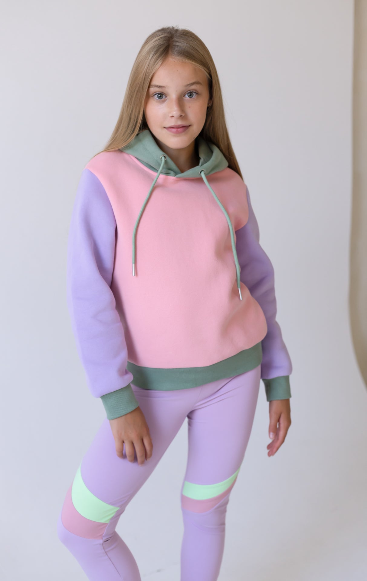 Pastel pink girls long hoodie jumper with mint hood, lavender sleeves, striped leggings