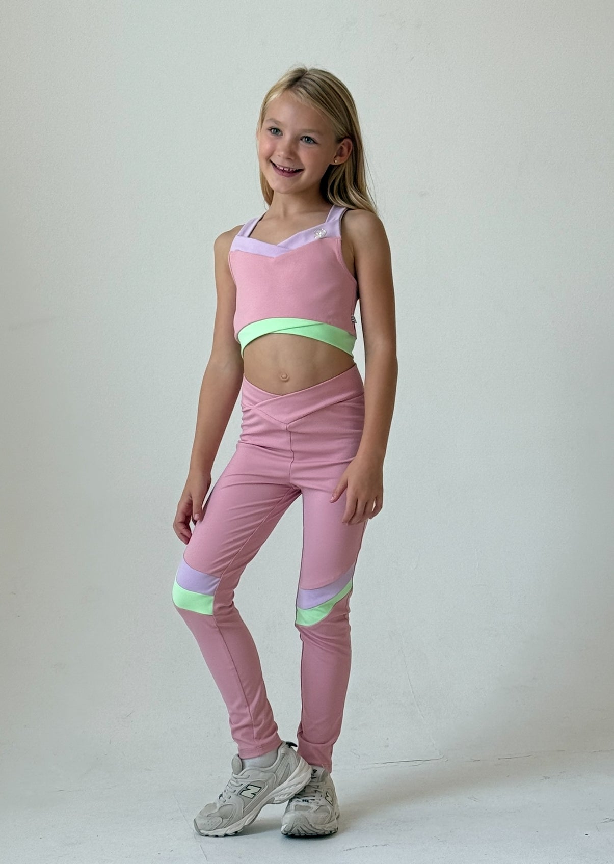 Pastel pink girls gym set: tank top and leggings with mint green trim, front view