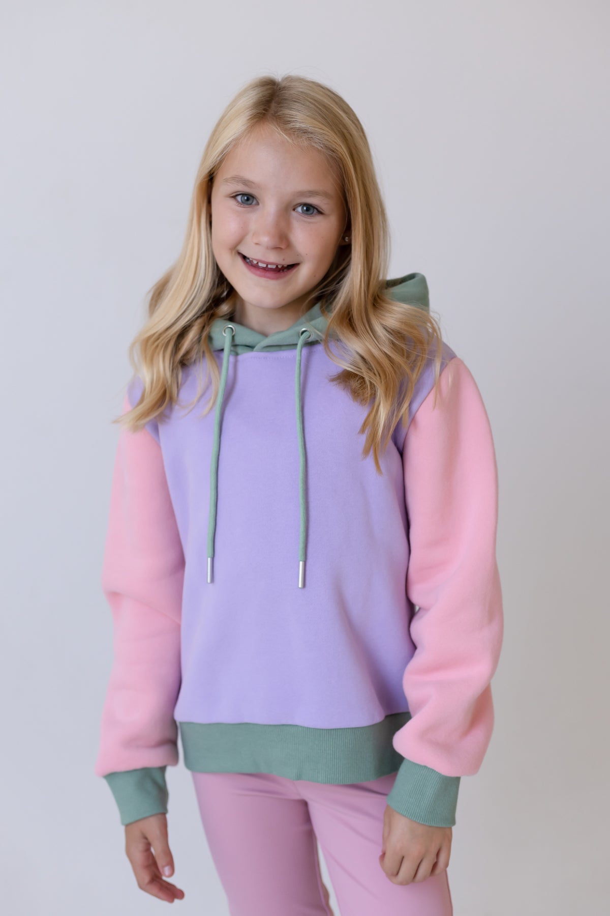 Pastel lilac girls long hoodie jumper with pink sleeves, green hood and drawstring