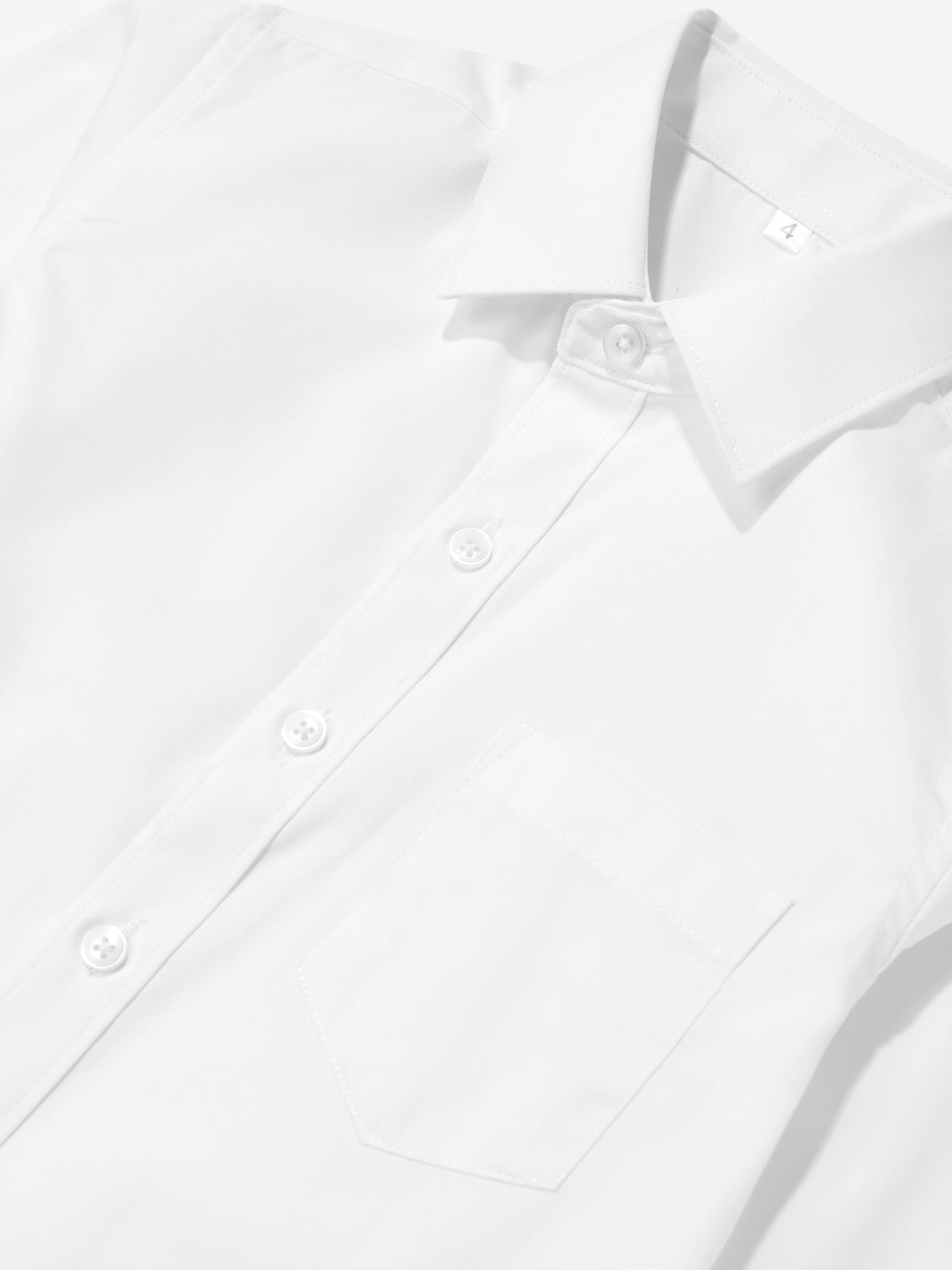 White cotton boys shirt close-up: button placket and chest pocket