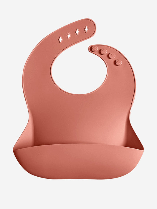 Pink silicone baby bib with snap closure and patterned top section