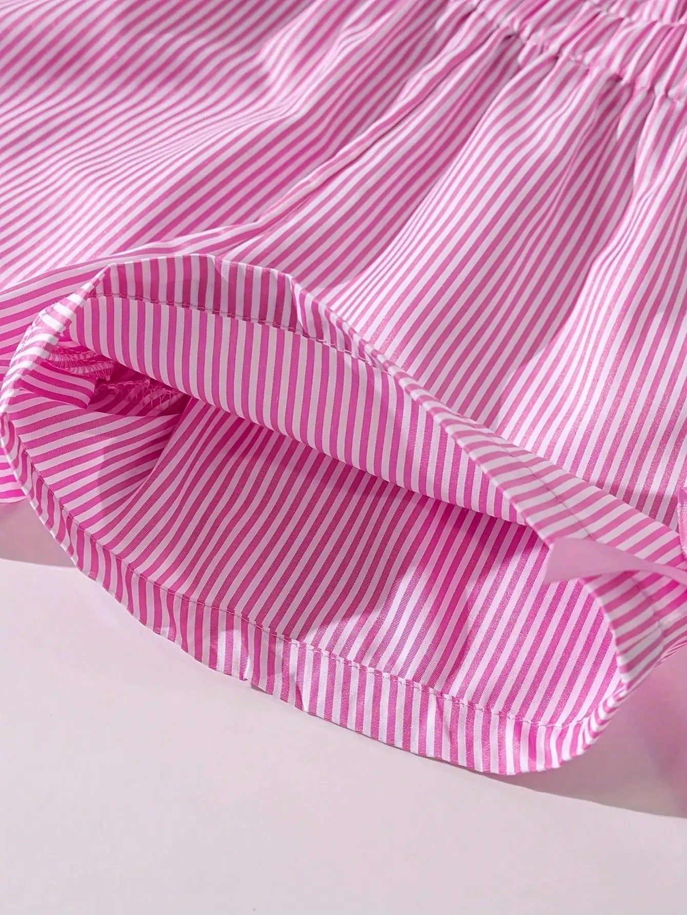 Girls pink striped ruffle trim with bow accent on shorts