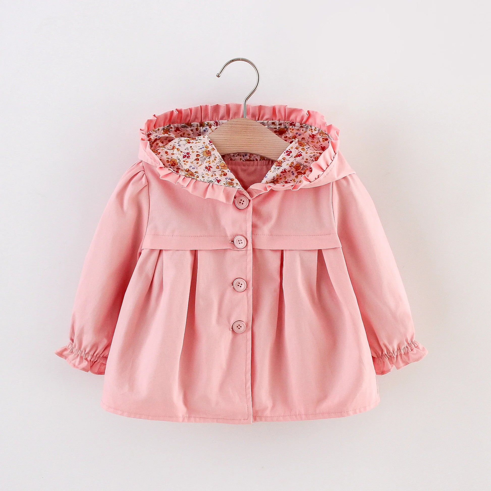 Baby light pink hooded jacket with ruffled hood, floral lining, and button front.