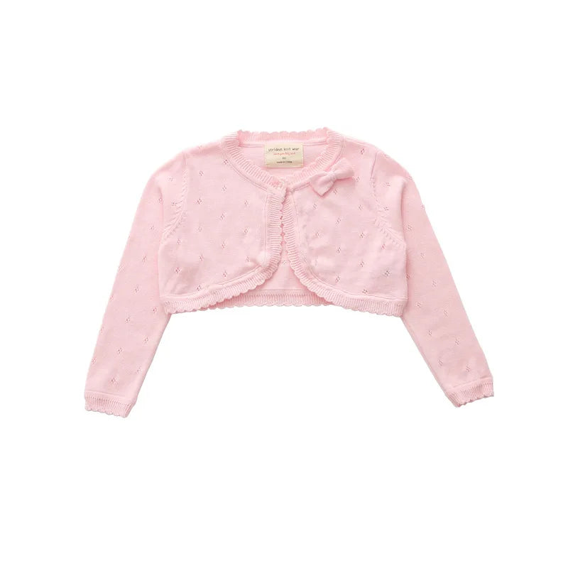 Kids knit cardigan, pale pink long sleeves, cropped with dotted texture and ruffle button placket
