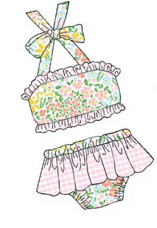 Girls floral swim set with bow bandeau top, ruffled edges, and pink check skirt