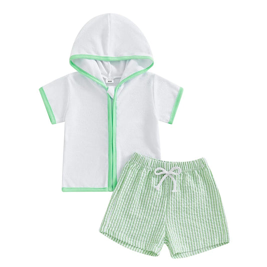 Children's hooded towel and green checkered shorts set on a white background