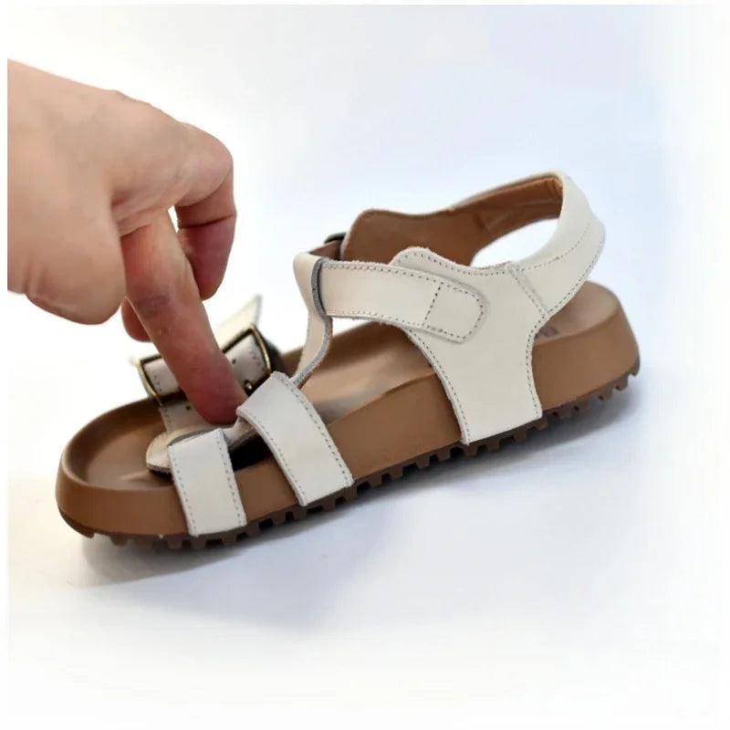 Kids white sandal with buckle straps and hook-and-loop closure; rugged sole