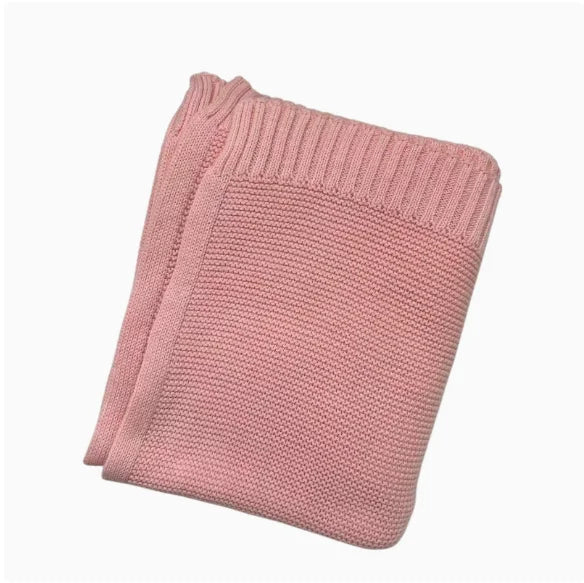Blush pink knitted baby blanket with stitched ribbed edge border