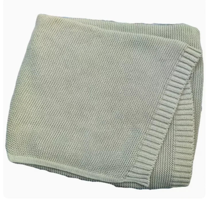 Sage green knitted baby blanket with stitched ribbed edge border