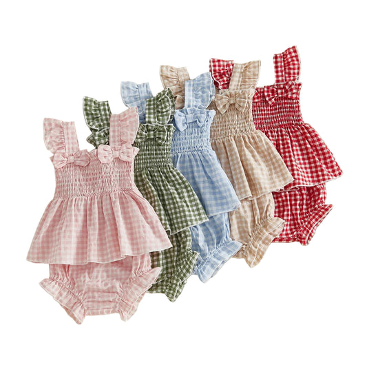 Set of colorful baby rompers on a beige background with flowers.