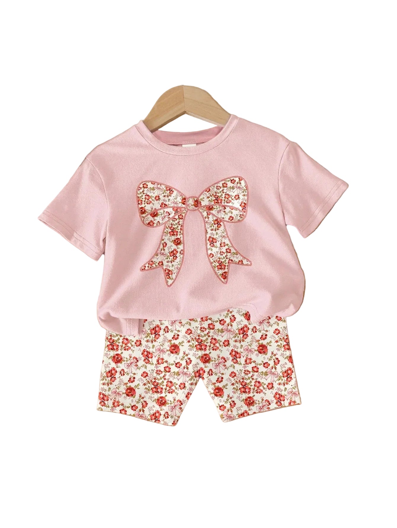 Pink T-shirt with floral bow and matching floral shorts, front view