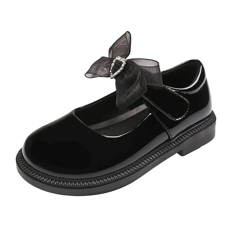 Black shoe with a decorative bow on a white background