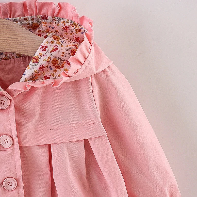 Baby light pink hooded jacket with floral-lined hood and ruffled collar.