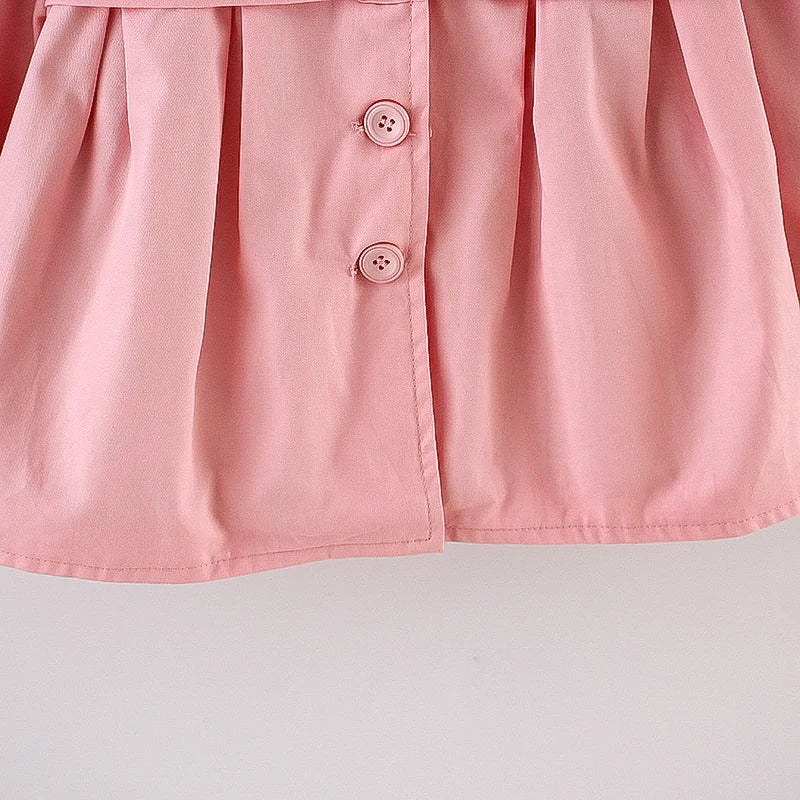 Baby light pink hooded jacket placket with three button closures.