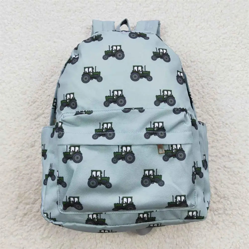 Light blue backpack with green tractor pattern on a light gray background