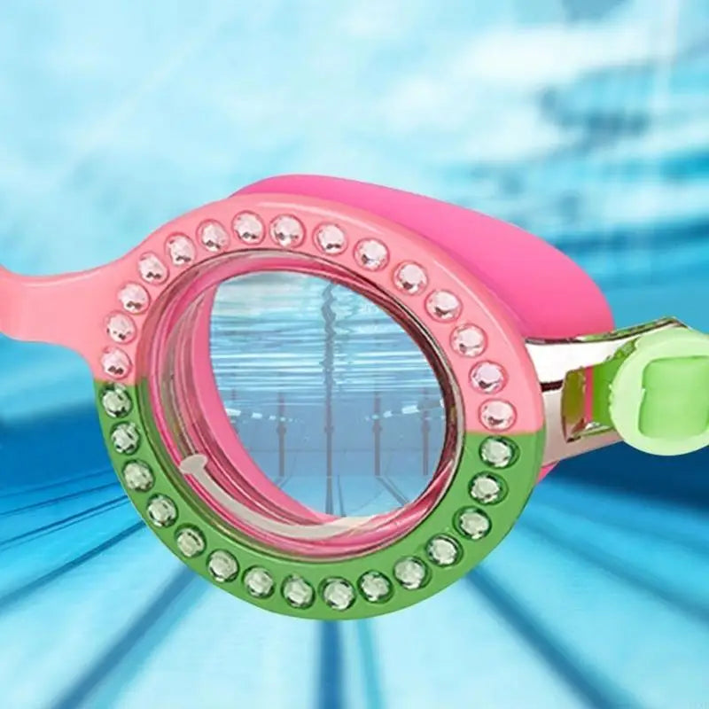 Pink and green girls swim goggles close-up with rhinestone border and mirrored lens