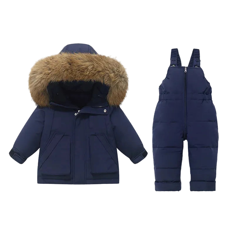 A children's winter outfit set consisting of a navy blue hooded puffer jacket with a brown faux-fur trimmed hood and matching navy blue snow bib overalls, displayed on a light gray background.