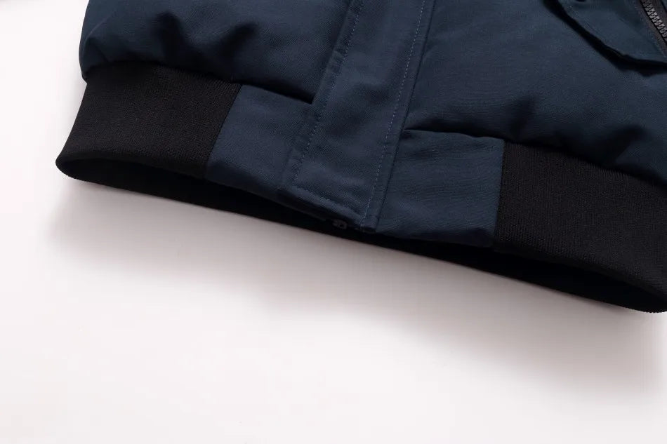 Folded navy blue jacket on a white background