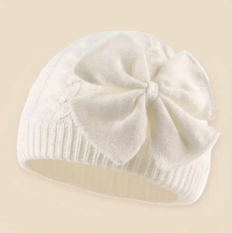White knitted bowknot beanie hat with ribbed brim