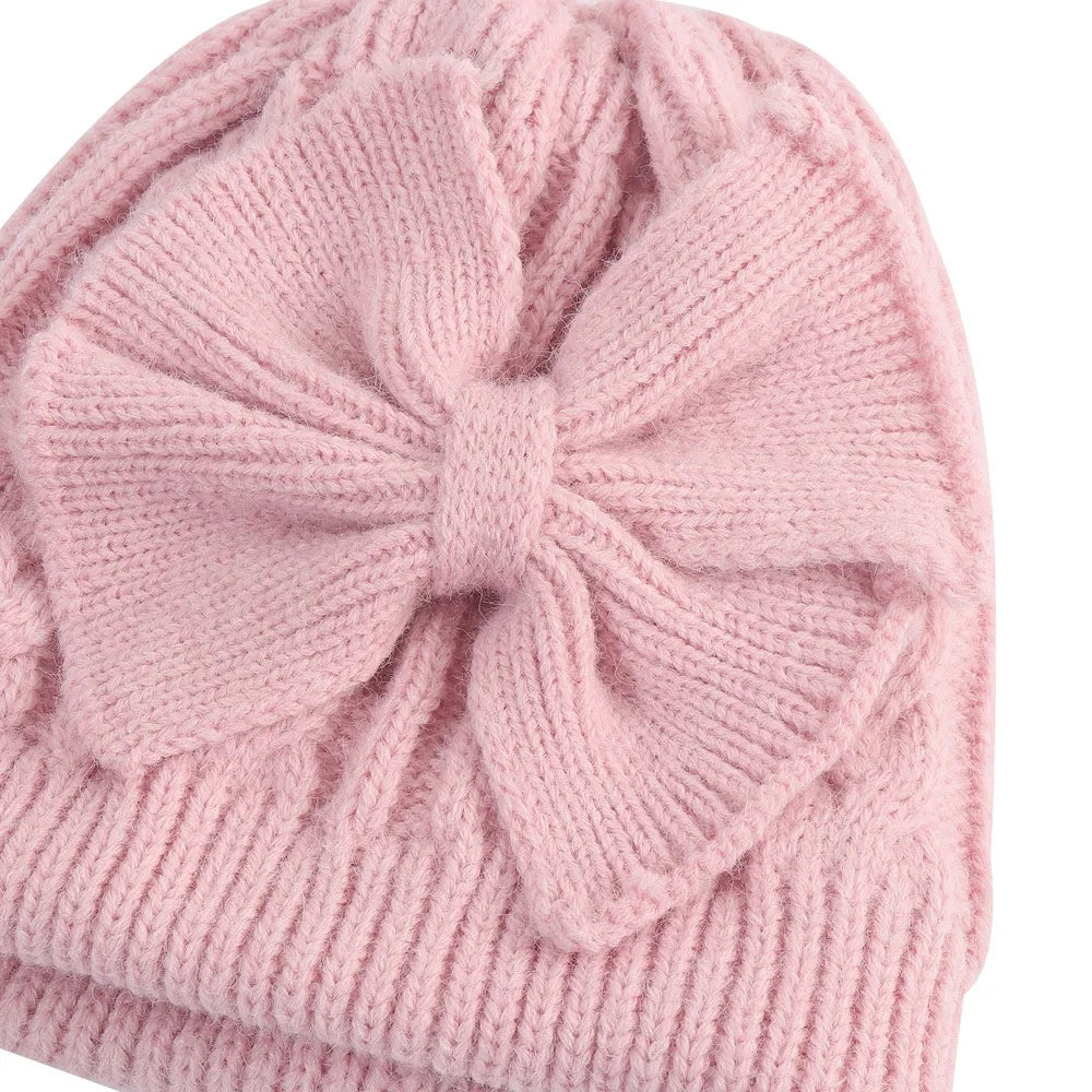 Pink knitted bowknot beanie hat with ribbed brim