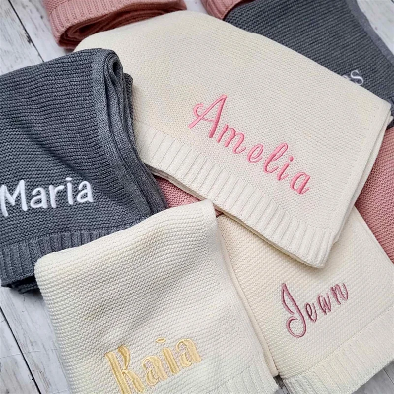 Personalized knit baby blankets in cream and gray with embroidered names Amelia and Maria