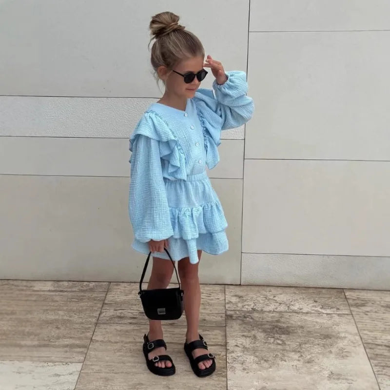Powder blue ruffle smock skirt and shirt set on child, tiered ruffles