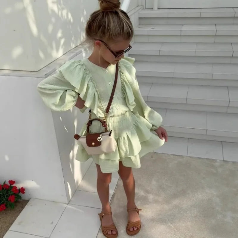 Mint green ruffle smock shirt and tiered skirt set, full body side view with layered hem